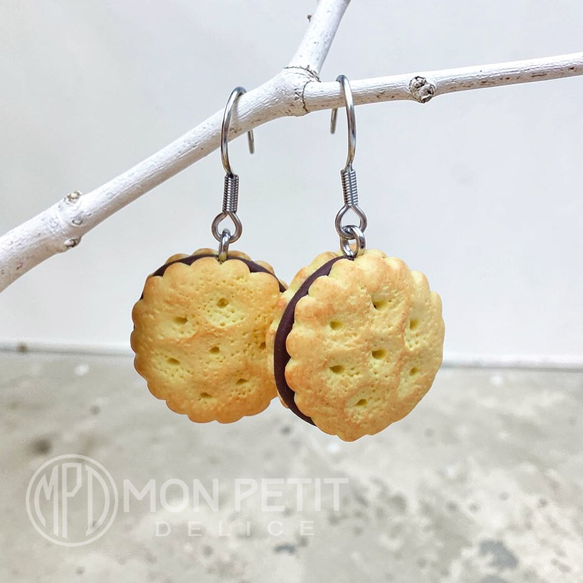 Realistic chocolate biscuit earrings kawaii jewelry hanging from a branch.