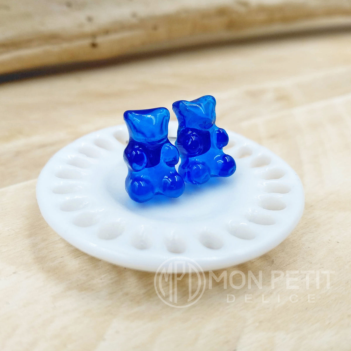 Detail view of blue gummy bear stud earrings by Mon Petit Delice