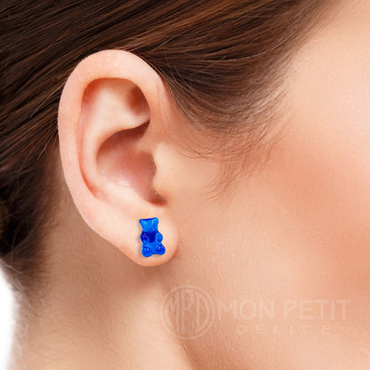 Blue gummy bear stud earring worn on the ear