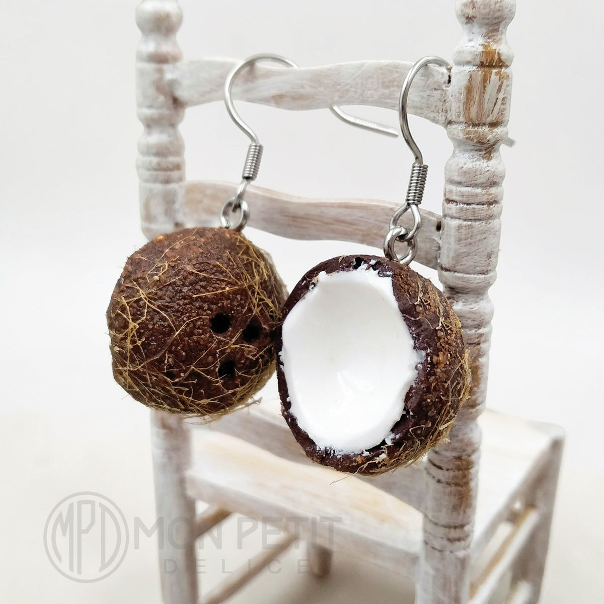 Side view of handmade coconut dangle earrings with stainless steel hooks
