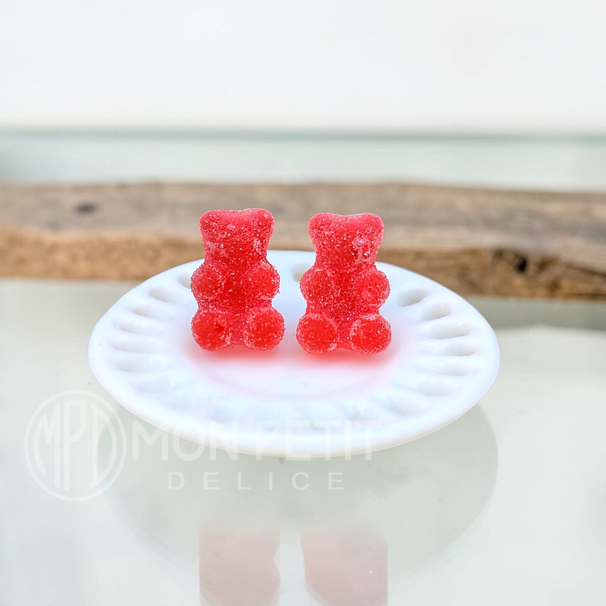 Red sugar gummy bear stud earrings handmade in resin, close-up view