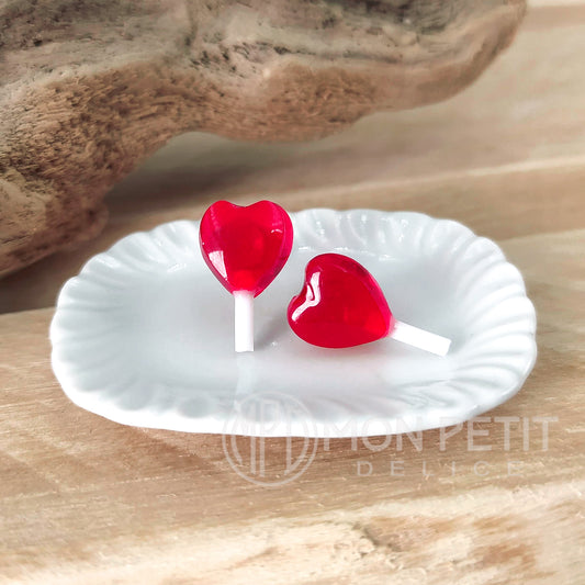 Red heart lollipop stud earrings handmade in resin, close-up view